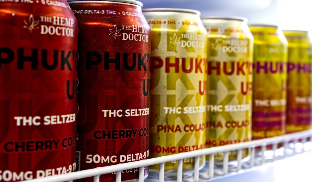 PHUK’D UP THC seltzers by The Hemp Doctor, available at Carolina Cloudz – featuring Delta-9 infused drinks like Cherry Cola and Piña Colada.
