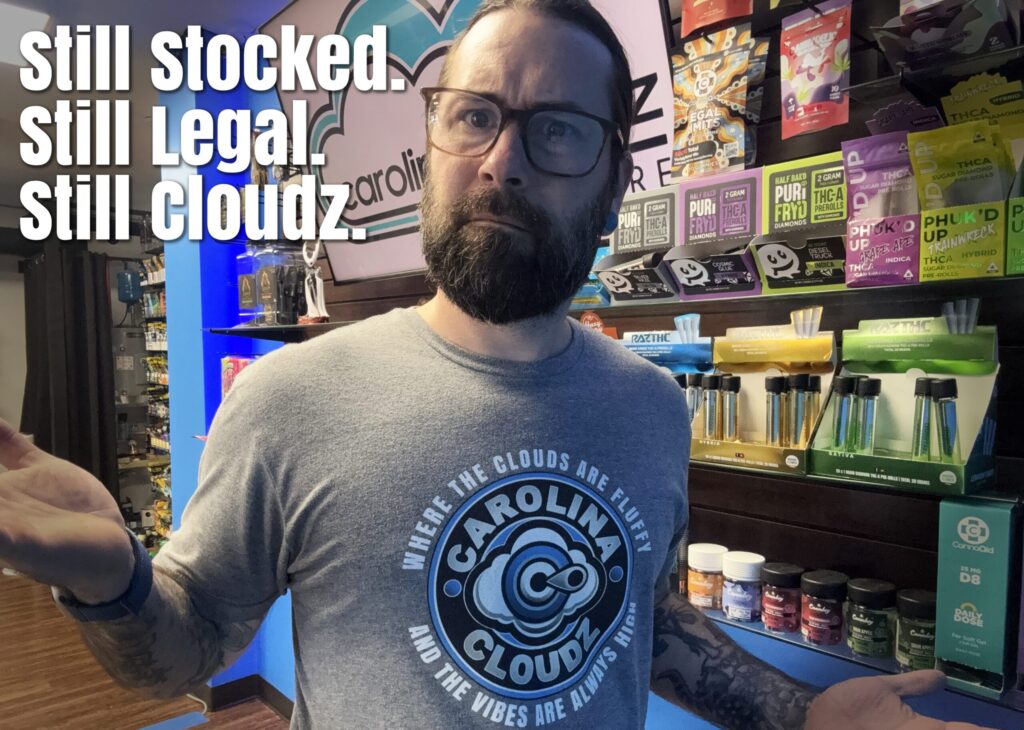 Carolina Cloudz owner shrugging in response to NC vape ban, with text 'Still Legal. Still Stocked. Still Cloudz'